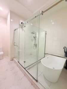 Luxury ensuite bathroom with freestanding bathtub, glass shower enclosure, and modern fixtures.
