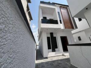 Modern luxury duplex exterior with balcony, contemporary architecture, and secure compound.