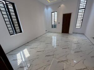 Spacious master bedroom with marble-effect flooring, large windows, and modern finishes in a luxury Lagos duplex.
